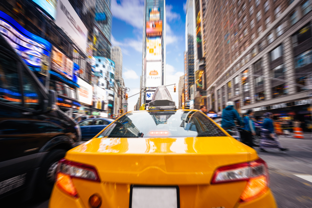 Taxi goes fast in Times Square, New York